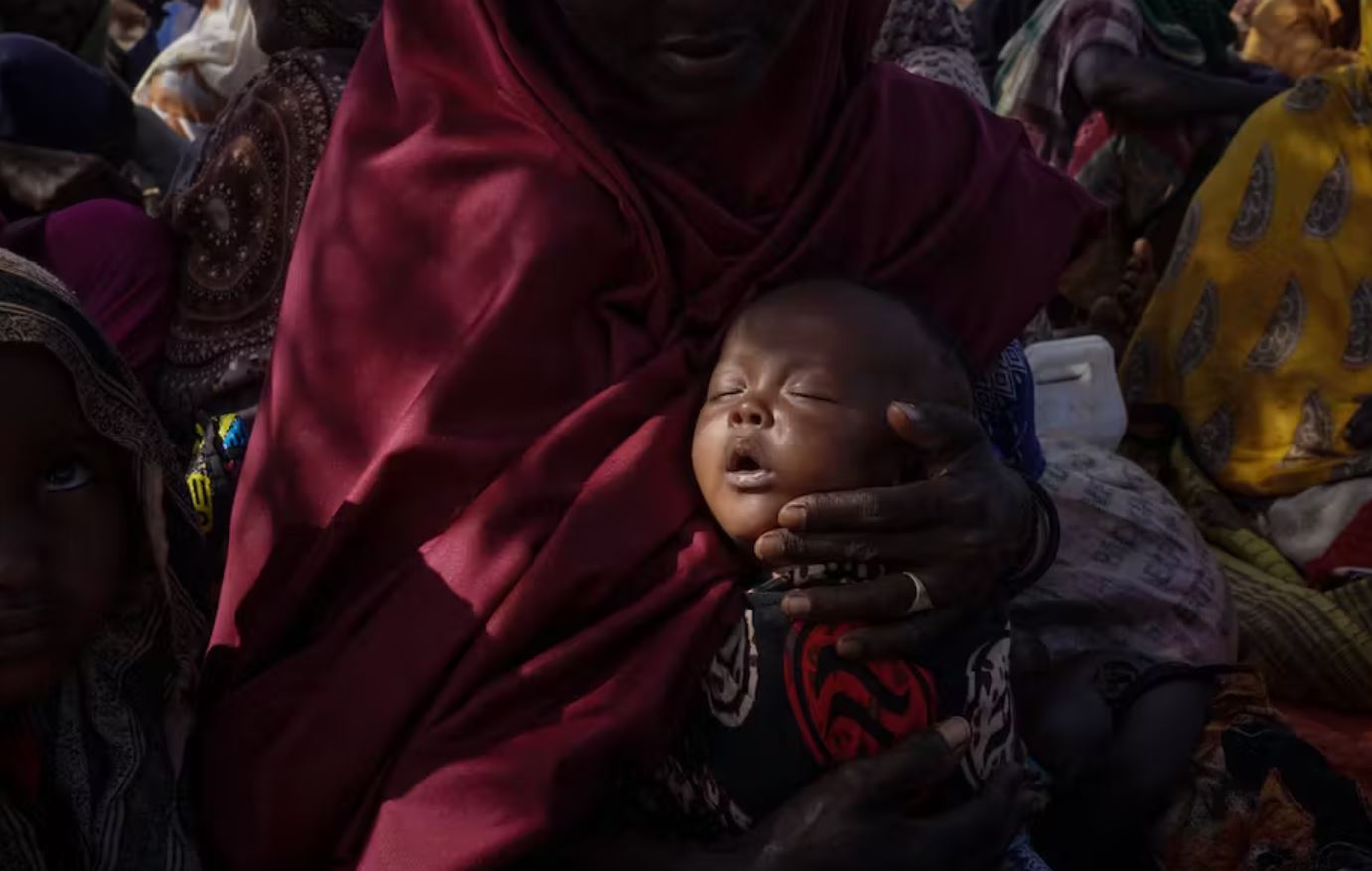 Mother and baby take refuge from drought and hunger at a refugee camp in Somalia. Giles Clarke via Getty Images