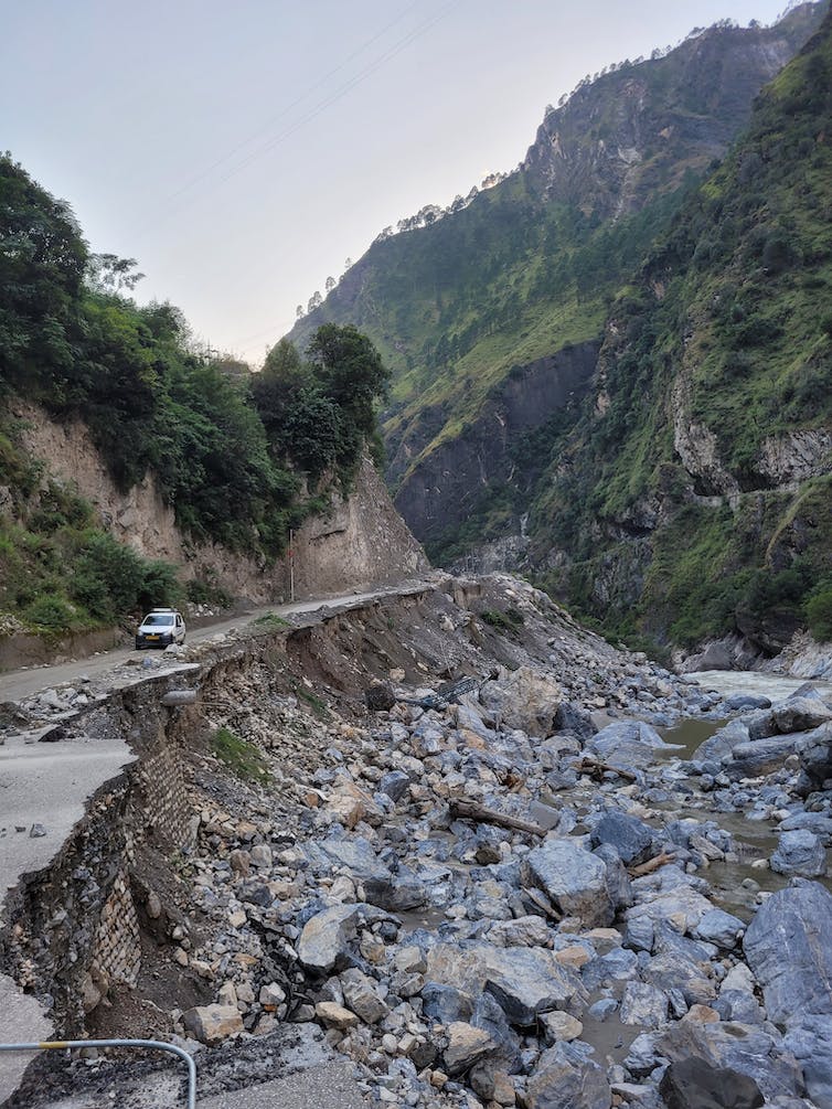 Collapsed road in valley, lots of boulders